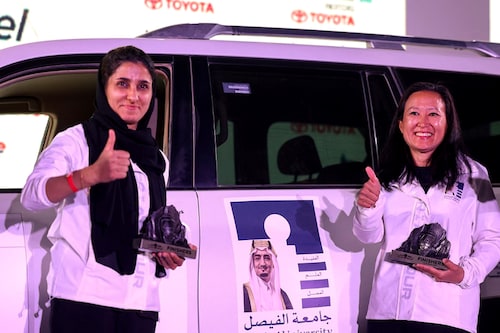 A picture taken on March 19, 2022 shows UAE"s driver Atefa Saleh (L) and her co-driver US Eleana Coker celebrating after they won the second place in Rally Jameel, Saudi ArabiaÃ­s first ever women only motor rally, in Riyadh on March 19, 2022. (Photo by Fayez Nureldine / AFP)