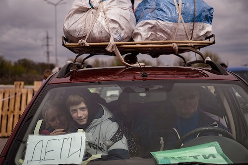 A Ukrainian family arrives in Zaporizhzhia after fleeting Russian-occupied Mariupol in Eastern Ukraine, April 21, 2022. Those arriving here from Mariupol today described cold, hunger and weeks living in basements, with days broken up only by quick dashes to the surface to cook paltry meals on open fires in the courtyard, amid neverending shelling. (Lynsey Addario/The New York Times)
