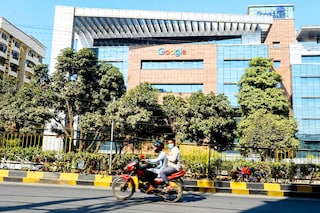 A motorist rides along a road in front of the Google India office building in Hyderabad on January 28, 2022. The Indian government on Wednesday unexpectedly withdrew a proposed bill on data protection that a panel of lawmakers had been laboring over for more than two years, saying it was working on a new law. Image: Noah Seelam / AFP
