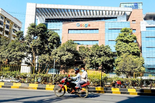 A motorist rides along a road in front of the Google India office building in Hyderabad on January 28, 2022. The Indian government on Wednesday unexpectedly withdrew a proposed bill on data protection that a panel of lawmakers had been laboring over for more than two years, saying it was working on a new law. Image: Noah Seelam / AFP