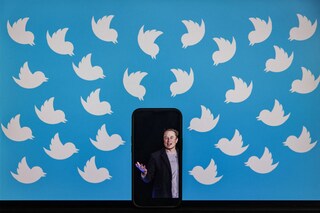 This file illustration photo taken on August 5, 2022 shows a cellphone displaying a photo of Elon Musk placed on a computer monitor filled with Twitter logos in Washington, DC. Elon Musk has sold nearly $7 billion worth of Tesla shares, according to legal filings published August 9, 2022, amid a high-stakes legal battle with Twitter over a $44 billion buyout deal. Image: SAMUEL CORUM / AFP