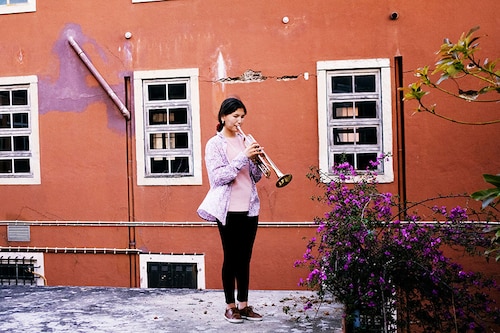 Zohra Ahmadi plays trumpet at the Afghanistan National Institute of Music compound, in Lisbon, Portugal, on May 8, 2022. Ahmadi was convinced from a young age that she wanted to be a professional musician. (Isabella Lanave/The New York Times)