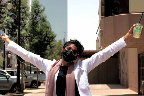 Safi, a 26-year-old Saudi physician, poses for a photo with her short hair near the Kingdom Centre skyscraper in the centre of Saudi Arabia"s capital Riyadh on June 19, 2022. Image: Fayez Nureldine / AFP