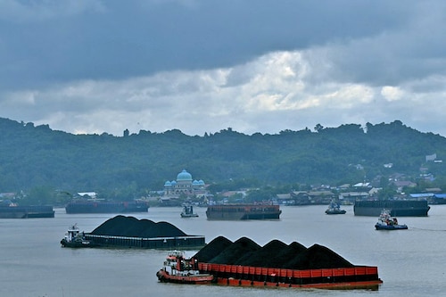 In this picture taken on August 16, 2022, piles of coal are seen on barges in Samarinda, East Kalimantan, Borneo. IEA called for international finance centres to channel funding and expertise more quickly to coal-dependent nations in order to accelerate their low-carbon transition. Image: Adek Berry/AFP  In this picture taken on August 16, 2022, piles of coal are seen on barges in Samarinda, East Kalimantan, Borneo. IEA called for international finance centres to channel funding and expertise more quickly to coal-dependent nations in order to accelerate their low-carbon transition. Image: Adek Berry/AFP 