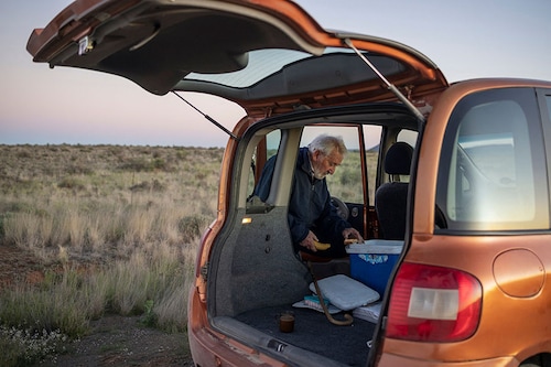 Francois Hugo, 89, owner and editor of the Noordwester, the Messenger and the Oewernuus, stops for a coffee break while driving to deliver his newspapers outside Vosburg.
Image: Michele Spatari / AFP