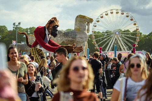 A showman manoeuvre an oversized figure in the form of a gorilla through the crowd at the Lollapalooza Festival in the Berlin Olympic Park Photo by Gregor Fischer/picture alliance via Getty Images