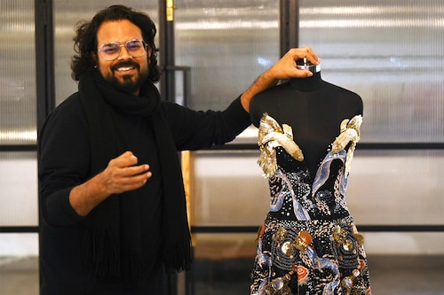 In this photograph taken on January 13, 2023, Indian fashion designer Rahul Mishra stands beside his new collection at his workshop in Noida. - For a man with seemingly infinite creative ambitions, it is fitting that Indian designer Rahul Mishra"s latest Paris haute couture collection attempts to encapsulate the entire universe.
Image: Money Sharma / AFP