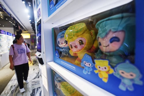 Adverts for the Asian Games and shops selling merchandise were widespread in Hangzhou, with pop-up events to commemorate the 100-day mark taking place at a railway station in the city. Image: STR / AFPÂ©, CHINA OUT