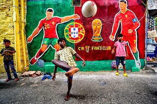 Children seen playing football in front of a graffiti wall with Cristiano Ronaldo (7) along the street as they celebrate FIFA World Cup 2022 in Kolkata.
Image: Avishek Das/SOPA Images/LightRocket via Getty Images