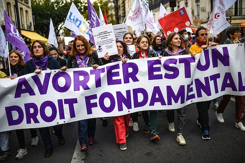 Demonstrators march behind a banner reading "Abortion is a fundamental right" as they take part in an abortion rights rally on the annual International Safe Abortion Day in Paris on September 28, 2022. Image: Christophe ARCHAMBAULT / AFP