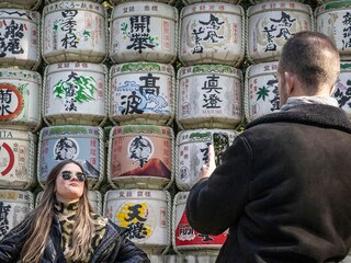 People take photographs of a display of sake barrels at Meiji Shrine in Tokyo.
Image: Yuichi Yamazaki / AFP©