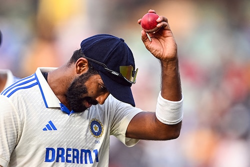 India"s Jasprit Bumrah shows a ball after taking 6 wickets at the end of England"s inning during the second day of the second Test cricket match between India and England at the Y.S. Rajasekhara Reddy Cricket Stadium in Visakhapatnam on February 3, 2024. Image: Dibyangshu Sarkar/ AFP