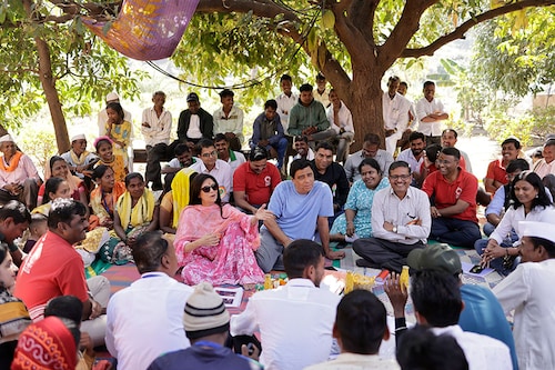 Zarina Screwvala (in pink kurta) and Ronnie (in blue T-shirt) at a community meeting in a village near Nashik where they work with the community. Image: Apoorva Salkade For Forbes India