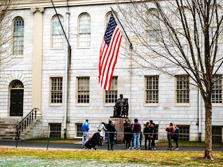 People gather around the John Harvard Statue on the Harvard University campus in Cambridge, Massachussetts, on April 15, 2025. Elite US university Harvard was hit with a $2.2 billion federal funding freeze on April 14 after rejecting a list of sweeping demands that the White House said was intended to crack down on campus anti-Semitism.
Image:  Joseph Prezioso / AFP