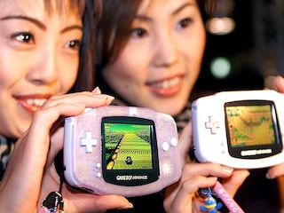 Japan"s video game giant Nintendo campaign with Ruriko Harada (L) and Jun Suzuki (R) displaying the new handheld consoles GameBoy Advance at a press preview in Tokyo in 2001&nbsp Image: Yoshikazu Tsuno / AFPÂ©