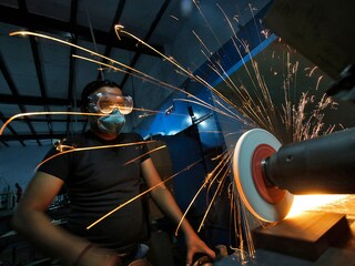 A worker operates a lathe machine as he makes a steel cutter at a manufacturing unit in Noida, on the outskirts of New Delhi.
Image: Reuters/Anindito Mukherjee