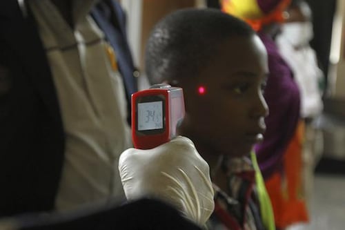 A boy's temperature is taken using an infrared digital laser thermometer at the Nnamdi Azikiwe International Airport. Nigeria's commercial capital Lagos has 10 confirmed cases of Ebola, up from seven at the last count, and two patients have died, including the Liberian who brought the virus in, the health minister said on Monday