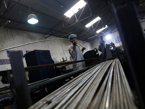 An employee holds a steel rod as he works on the production line inside Hallmark steel factory in Bhiwadi in the desert Indian state of Rajasthan September 30, 2013. India's prolonged economic slide has affected many companies in India, but small and medium-sized firms have been hit the most because of their more limited access to finance. REUTERS/Adnan Abidi (INDIA - Tags: BUSINESS EMPLOYMENT) - RTR3FKJ3