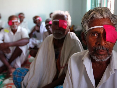 Patients with their eyes bandaged sit after their cataract surgeries at a hospital of the Aravind Eye Care System in Madurai, in India's Tamil Nadu state March 3, 2010. From a rented house with 11 beds in 1976, Aravind, whose mission is to eliminate needless blindness, has grown into a network of hospitals and clinics that provides eye examinations, surgery by keeping its costs extremely low and by subsidizing care for poor people through fees for paying customers and the sale of eye-care products. Picture taken March 3, 2010.  REUTERS/Reinhard Krause (INDIA - Tags: HEALTH SOCIETY) - GM1E6360UDZ01