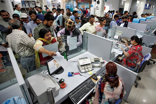 People stand in queues at cash counters to deposit and withdraw money inside a bank in Chandigarh, India, November 10, 2016. Ajay Verma/ REUTERS - D1BEULZMQEAA