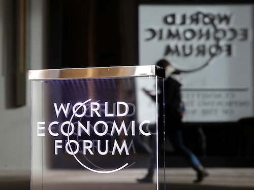 A person passes by a World Economic Forum logo in Davos, Switzerland, January 20, 2019. REUTERS/Arnd Wiegmann - RC1BAEE883B0