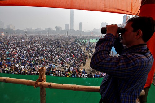 A police officer looks through a pair of binoculars during the 