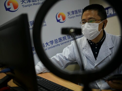 TIANJIN, CHINA - MARCH 04: A Respiratory and Critical Care Medicine department doctor communicates with patient via Tianjin Medical University General Internet Hospital platform on March 4, 2020 in Tianjin, China. Tianjin Medical University General Hospital offers online service amid novel coronavirus outbreak. Over a hundred doctors of the hospital communicate with patients via video call, voice call and graphics. People can consult doctors, get prescriptions, view checking results online and get medicines by express delivery. (Photo by Tong Yu/China News Service via Getty Images)