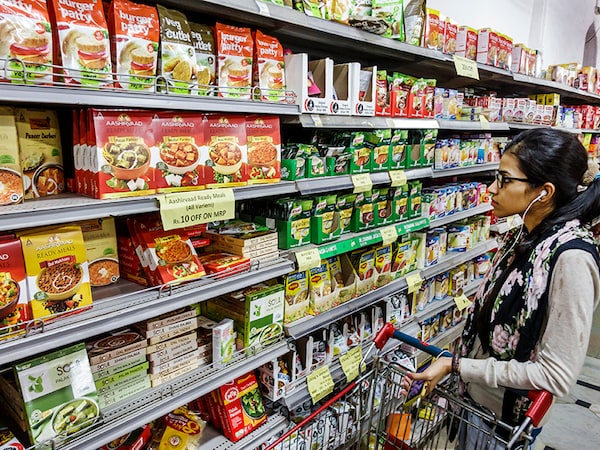 India Mumbai Colaba Mahatma Gandhi Road Sahkari Bhandar Sahakari grocery store supermarket inside shopping food display sale woman ready prepared meals instant. (Photo by: Jeffrey Greenberg/Universal Images Group via Getty Images)