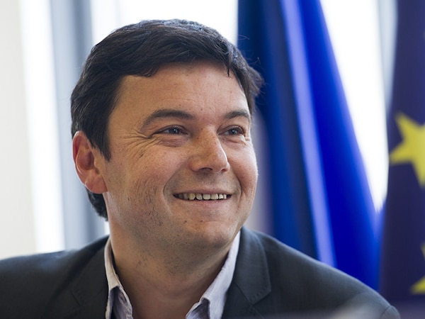 French economist Thomas Piketty smiles during a meeting at the National Assembly on March 13, 2013 in Paris.  AFP PHOTO / FRED DUFOUR        (Photo credit should read FRED DUFOUR/AFP via Getty Images)