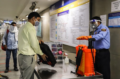 Passengers are being disinfected before taking Delhi metro, on the first day of the restart of their operations, over five months suspension due to COVID-19 outbreak in New Delhi on September 7, 2020. Image: Amarjeet Kumar Singh/Anadolu Agency via Getty Images