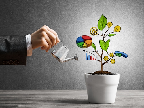 Hand of businesswoman watering concept of business plan and strategy