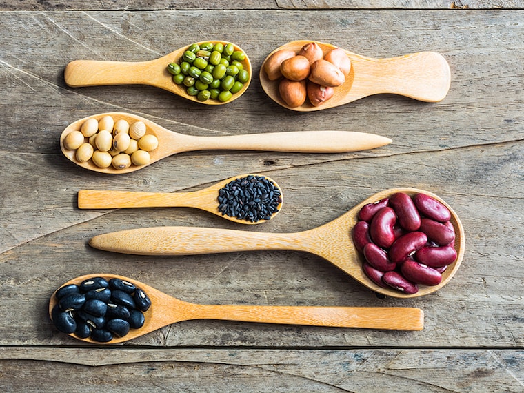 Group of beans and lentils in spoon made wood on wodden background. mung bean, groundnut, blackbean, black seasame, red kidney bean