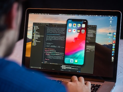 Bishkek, Kyrgyzstan - January 17, 2019: Man developer launches xcode software and ios simulator program to develop ios app on a MacBook