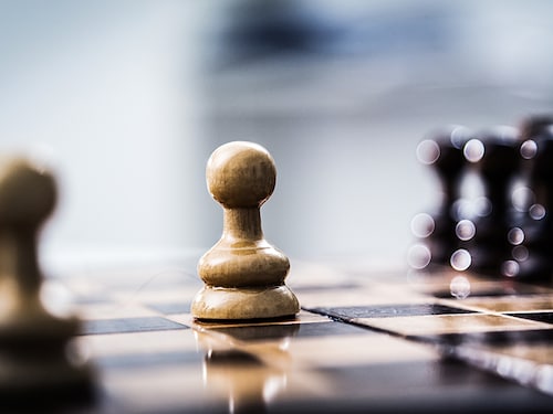One pawn staying against full set of chess pieces.