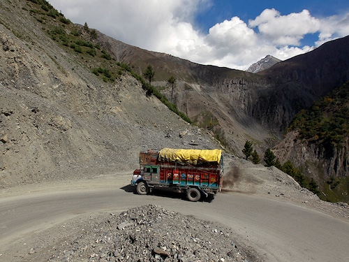 A goods truck drives on a mountainous road before the foundation stone laying ceremony for a tunnel on the Srinagar-Leh highway in Zojila, 108km (67 miles) east of Srinagar, October 4, 2012. A foundation stone laying ceremony for a tunnel on the 443km (275 miles) long highway connecting Kashmir with the Buddhist-dominated Ladakh region was held by the authorities in Sonamarg on Thursday. The authorities are planning to construct two tunnels, one at Z-Morh (6.5km long) and another at Zojila Pass (13km long), which is 3,530 metres (11,581 feet) above sea level and remains snowbound for six months of winter, authorities said.    REUTERS/Fayaz Kabli     (INDIAN-ADMINISTERED KASHMIR - Tags: ENVIRONMENT TRANSPORT) - GM1E8A41S4101