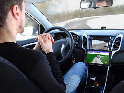 A man in a Autonomous driving  test vehicle