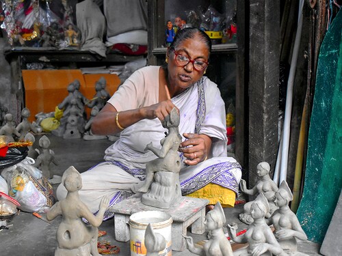 KOLKATA, WEST BENGAL, INDIA - 2020/09/26: A woman idol maker is making idols in Kumortuli. The idol makers of Kumortuli are preparing for the Upcoming Durga Puja Festival, which is one of the biggest festivals in India. Due to Covid-19 Pandemic their business is going down and many orders are cancelled. (Photo by Sudipta Das/Pacific Press/LightRocket via Getty Images)