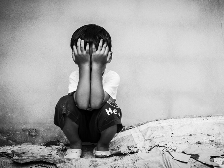 Sad boy sitting alone concept for bullying, depression stress or frustration,vintage tone