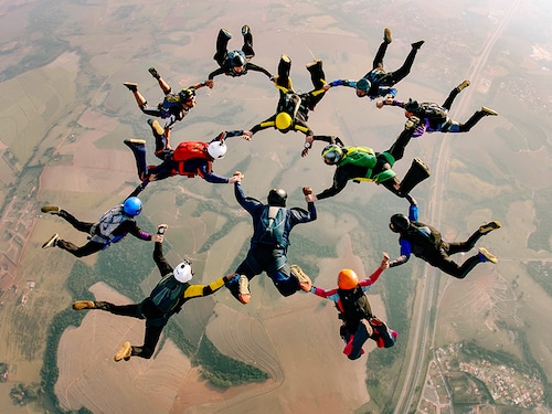 Skydivers holding hands making a fomation. High angle view.