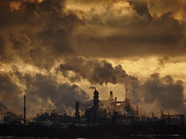 The plant emits smoke and smog from the pipes at sunset, pollutants enter the atmosphere. Environmental disaster. Harmful emissions into. Exhaust gases. Metallurgical industry against the sky.