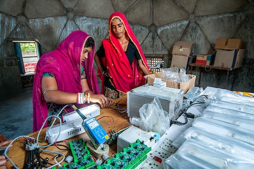 Rural women of Rajasthan making electric circuit to bring electricity from solar energy to their village