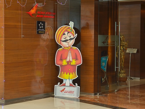 New Delhi, India 2020. Maharaja in front of Air India Star alliance business traveler lounge Terminal T3, Indira Gandhi Airport. Many credit cards give free global access to lounges to frequent flyers
