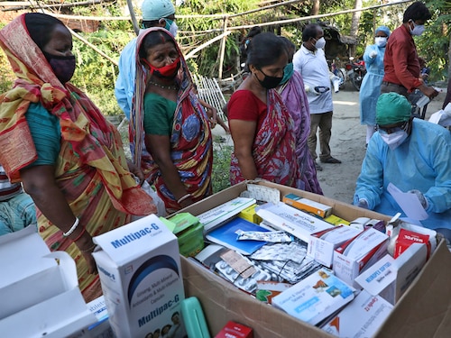 Villagers wait to receive medicine at a free medical camp set up to provide healthcare support to villagers, amidst the spread of the coronavirus disease COVID-19), at Debipur village in South 24 Parganas district in the eastern West Bengal state, India, May 21, 2021. REUTERS/Rupak De Chowdhuri - RC2BKN9ESXKV
