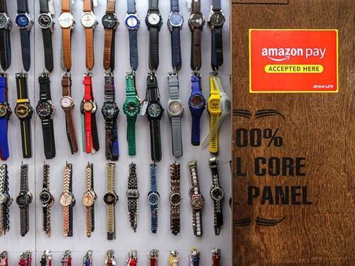 A watch store advertises the use of the Amazon Pay digital payment system in Mumbai, India, on Saturday, July 17, 2021. India had a record $6.3 billion of funding and deals for technology startups in the second quarter, while funding to China-based companies dropped 18% from a peak of $27.7 billion in the fourth quarter of 2020, according to data from research firm CB Insights. Photographer: Dhiraj Singh/Bloomberg via Getty Images