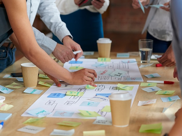 Brainstorming session with post it notes on desk