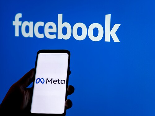 Moscow, Russia - Oct 30 2021: Social media platform will change to Meta to emphasize its metaverse vision.. Smartphone with Meta logo on background of Facebook logo. Renaming and rebranding