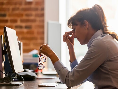 Stressed overworked middle aged businesswoman office worker taking off glasses tired from computer work feeling headache, dry eye strain, bad blurry weak vision eyestrain tension problem concept