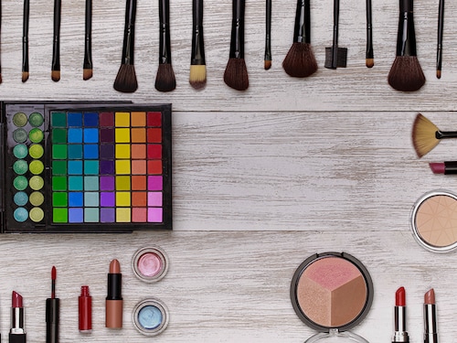 Top view on set of cosmetics for professional make-up  on wooden background