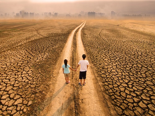 Climate change and Environmental Pollution, Drought impact to river and lake around the city with two children standing on dirty road.