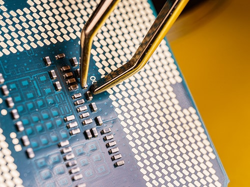 production of central processing units, tweezers working over a a cpu.